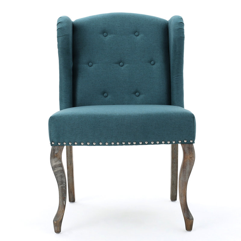 Élégant fauteuil à oreilles bleu sarcelle avec pieds et capitonnage