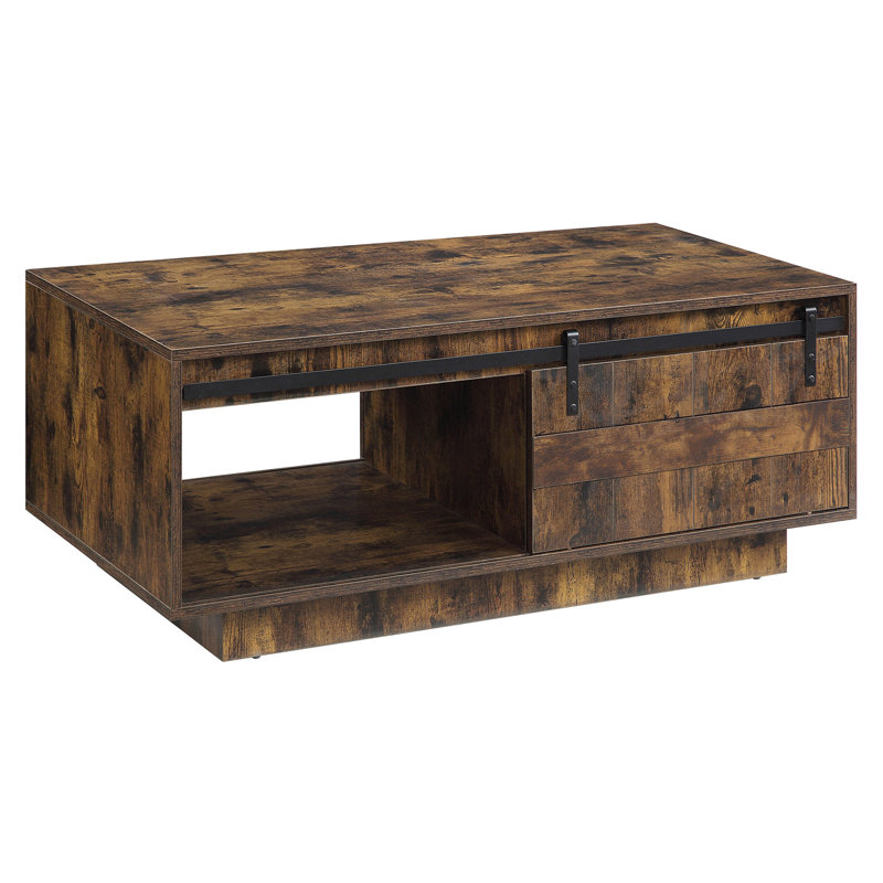 Table basse rustique en chêne avec porte de grange coulissante, parfaite pour un décor de maison de campagne et des solutions de rangement polyvalentes.