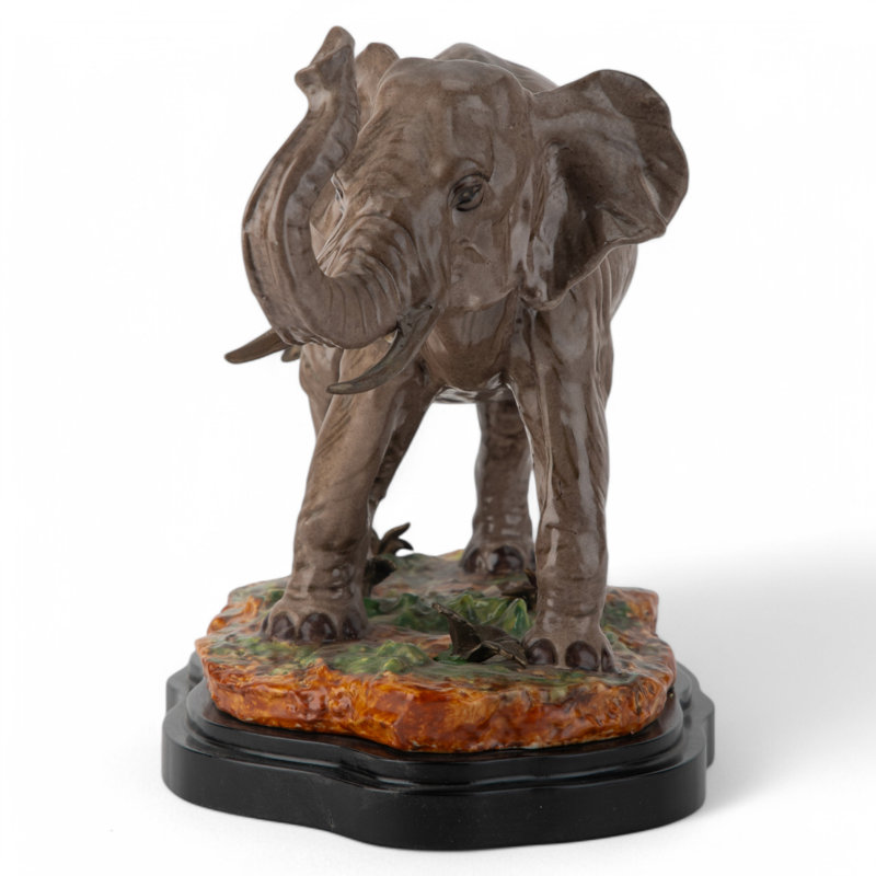 Porcelain Elephant Figurine With Bronze Tusks and Tail Accents On Wood Base
