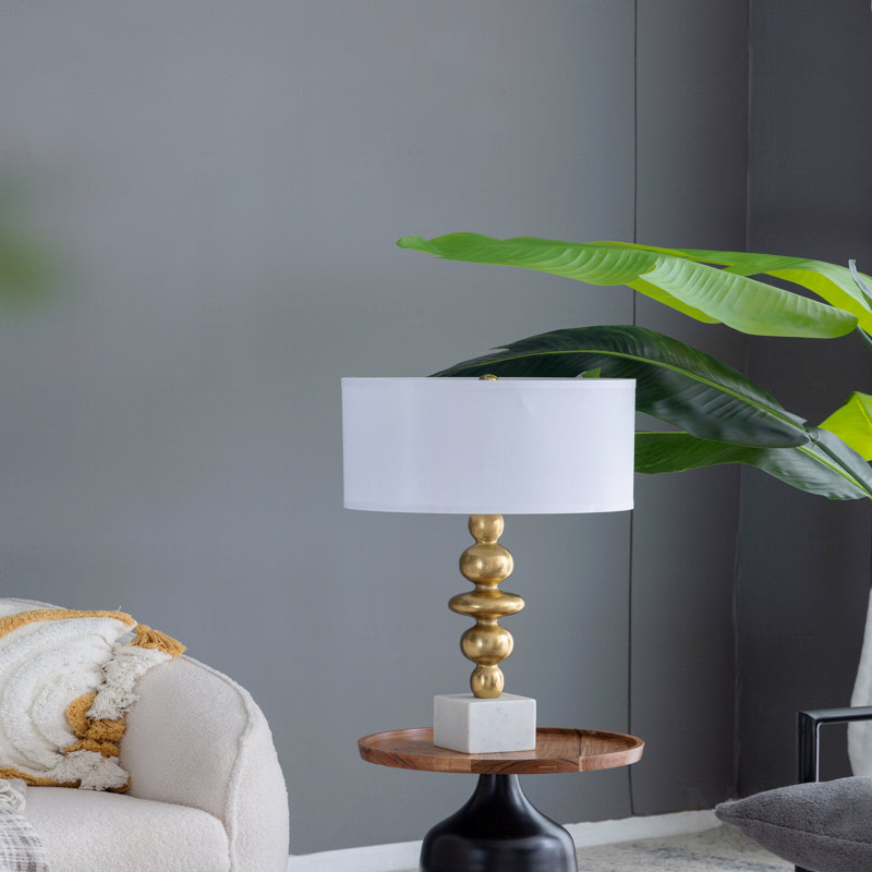 Lampe de table, en or et blanc, avec un corps rond à quatre niveaux