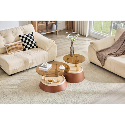Luxury-inspired brown and gold nesting coffee table set. Set of two tiered coffee tables with tea-stained tempered glass. Round living room coffee table