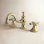 Kingston Brass Vintage Two-Handle 3-Hole Deck Mount Widespread Bathroom Faucet with Brass Pop-Up Drain