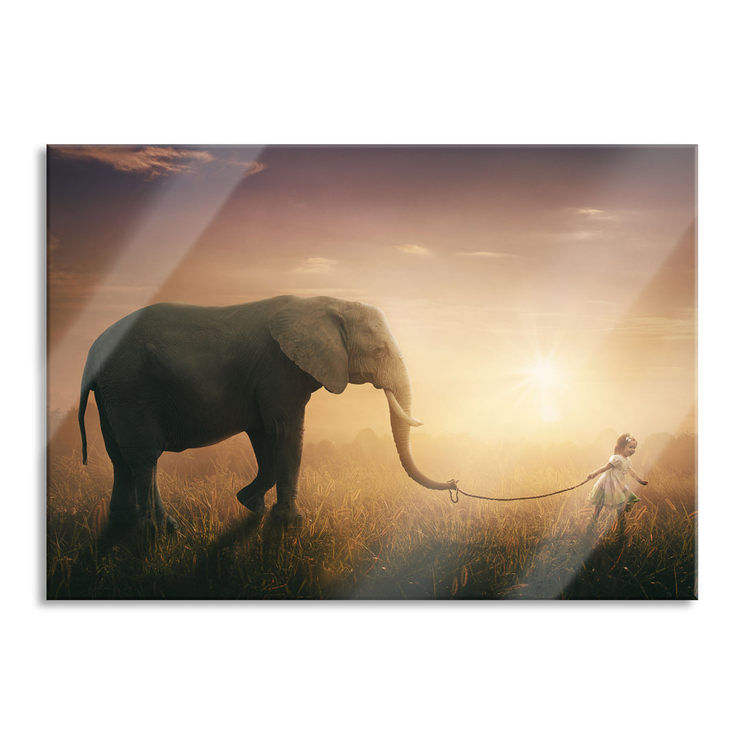 Glasbild Kind und Elefant bei Sonnenuntergang