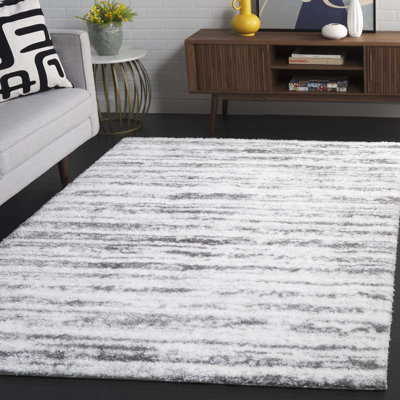 Tapis en polyester tissé à la machine Arbelia en ivoire / gris foncé