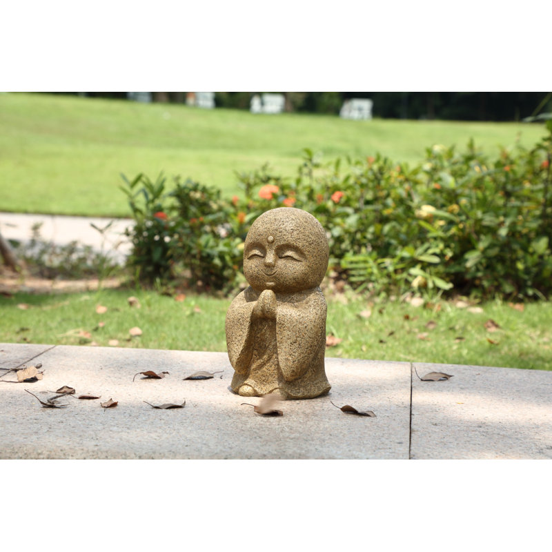 Statue Jizo japonais heureux et priant