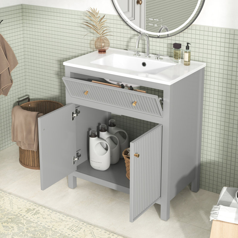 Meuble-lavabo moderne autoportant avec lavabo en céramique et portes à fermeture douce pour une fonctionnalité élégante et silencieuse.