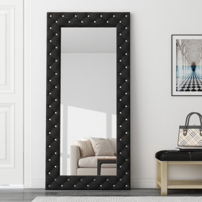 Grand miroir de sol noir capitonné Casmer