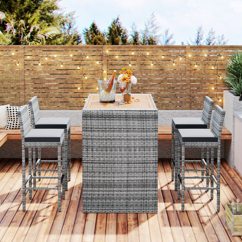 Severin Rectangular 4 - Person Long Bar Height Dining Set with Cushions