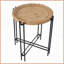 Table basse ronde moderne en bois avec pieds en métal, contraste saisissant pour le salon