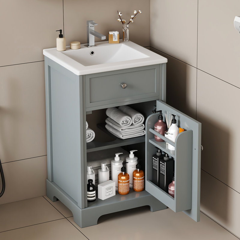 Meuble-lavabo de salle de bain de 50 cm (20 po) de couleur grise, avec un seul lavabo et une poignée de porte ronde. Style moderne avec lavabo en céramique blanche et grand espace de rangement pour une salle de bain bien rangée.