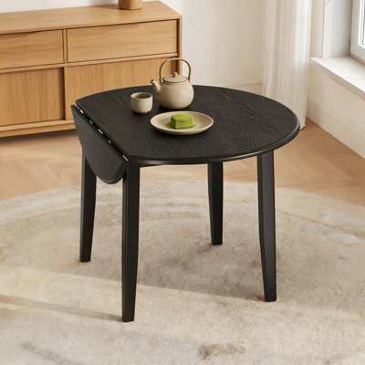 Table de salle à manger extensible ronde pour 2 à 4 personnes avec un design pliable et une fonctionnalité peu encombrante.