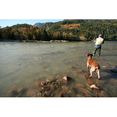" Man Fishing On A Lake With A Dog "