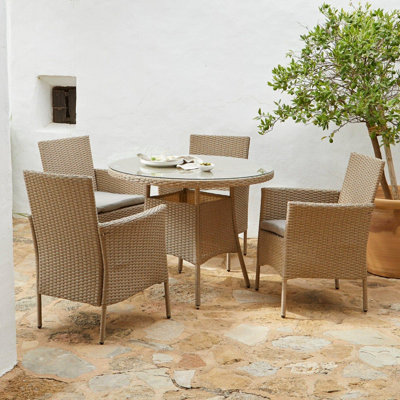 Dubose 4 - Person Wicker Patio Dining Set with Round Table , Cushions Included