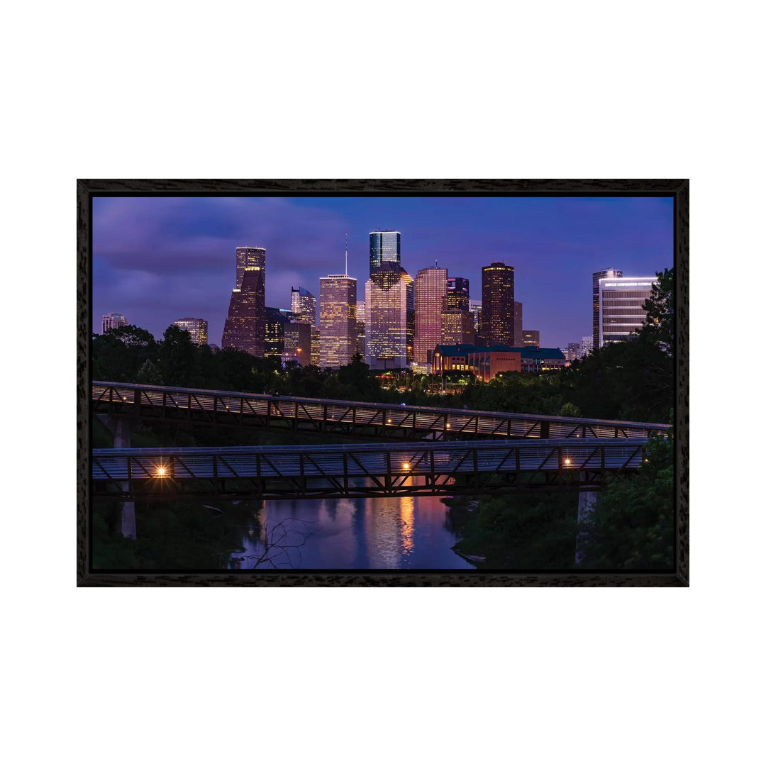 Erhöhter Gehweg über Buffalo Bayou bei Nacht mit der Skyline der Innenstadt im Hintergrund, Houston, Texas