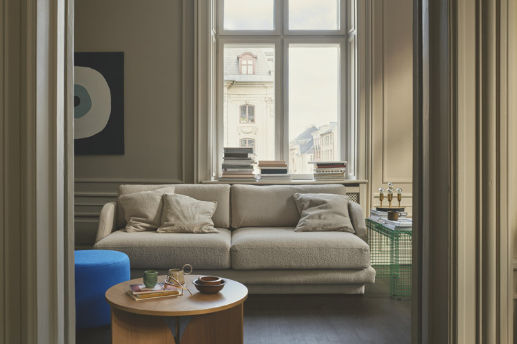 how to decorate your first apartment tips with a modern cream colored sofa and modern furnishings in an apartment