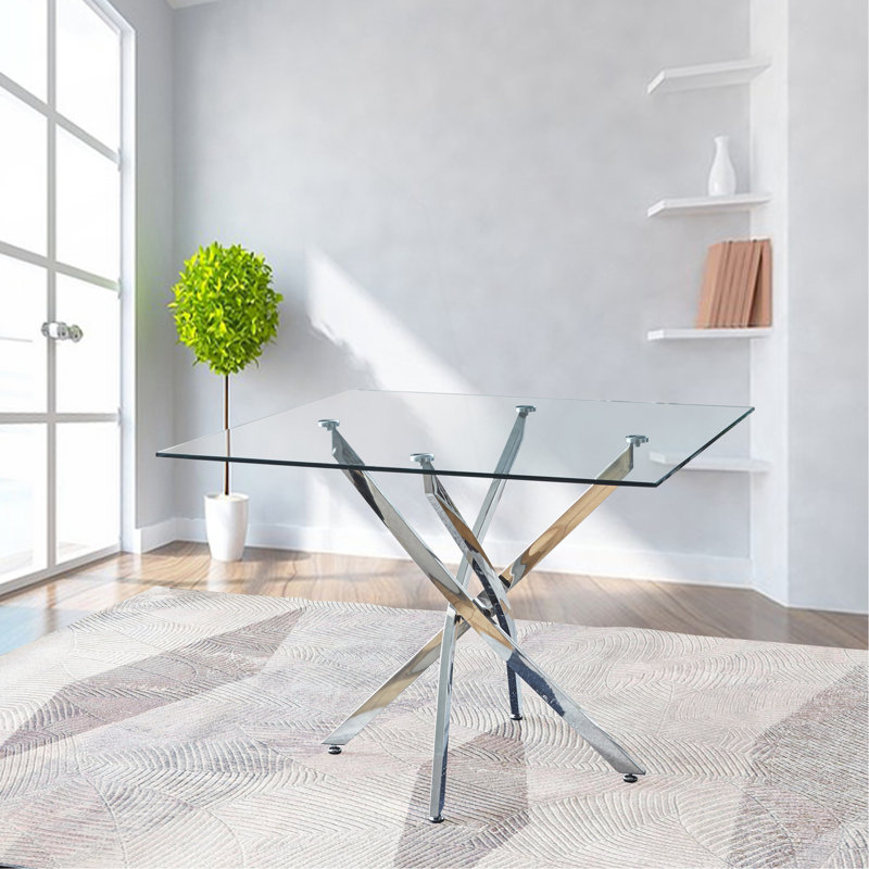 Table de salle à manger moderne en acier inoxydable et en verre avec un design élégant et une fabrication robuste.