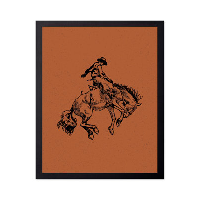 Cowboy brun chevauchant un cheval sauvage