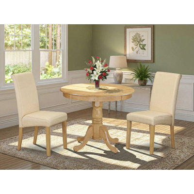 L'ensemble 3 pièces de table et chaises de cuisine comprend une table de salle à manger ronde avec piédestal et 2 chaises Parson en tissu de lin beige clair, chêne