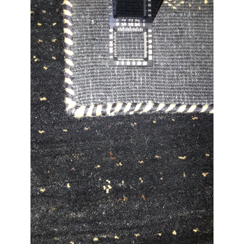Ovide Polka Dots Area Rug in Black