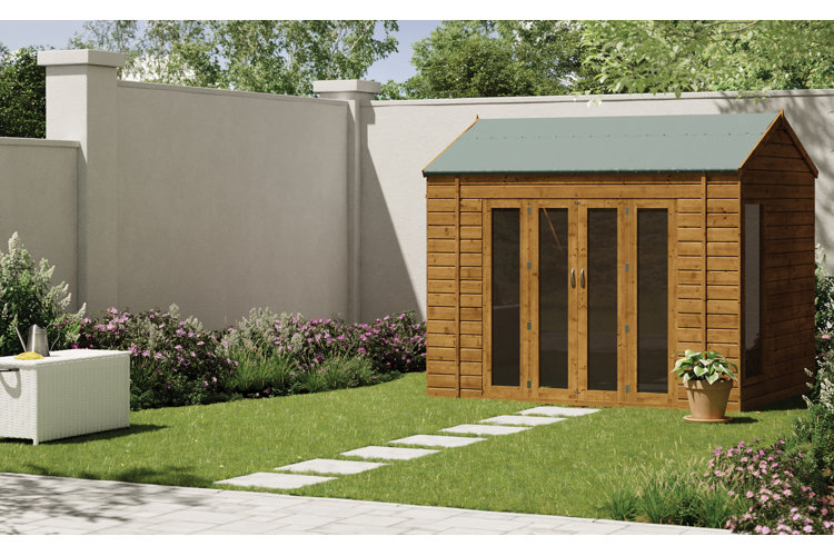 Backyard with a paving stone pathway leading from the patio through the grass to a wood garden shed.
