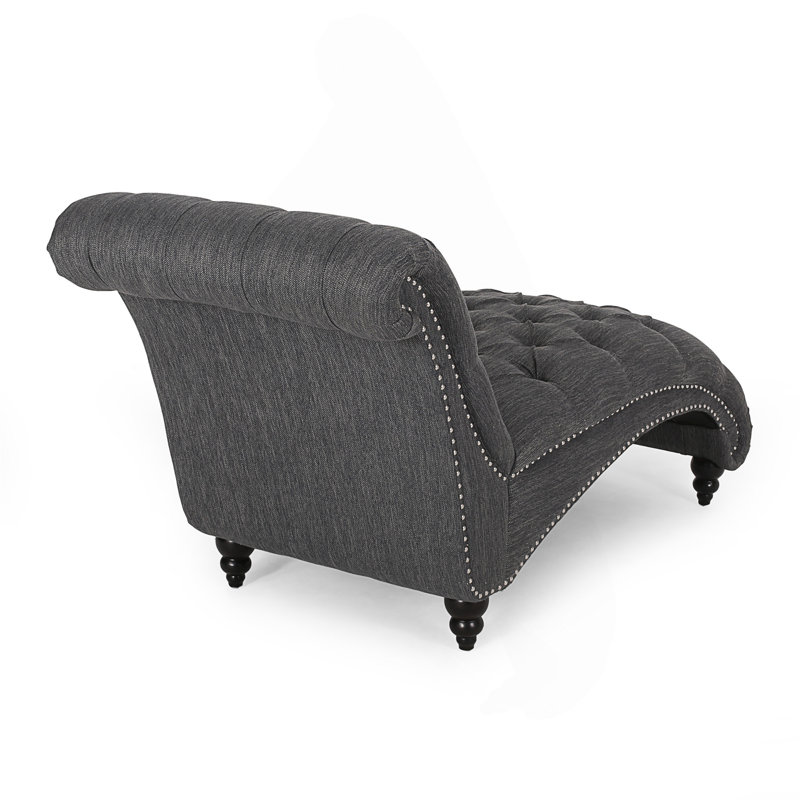 Chaise longue élégante avec un design tout en courbes, un capitonnage à boutons et des pieds en bois de bouleau pour un confort et un style ultimes.