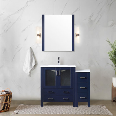 Meuble-lavabo bleu marine de 107 cm de large avec armoire latérale, surface en céramique blanche, miroir de 71 cm, tiroirs à fermeture amortie et grand espace de rangement intégré. Fixation murale.