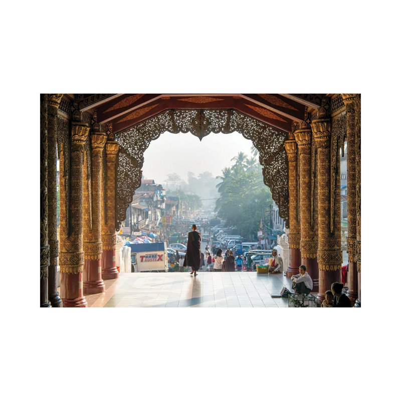 Buddhist Monk Passing The Entrance Of The Shwedagon Pagoda In Yangon, Myanmar by Jan Becke - Wrapped Canvas Print