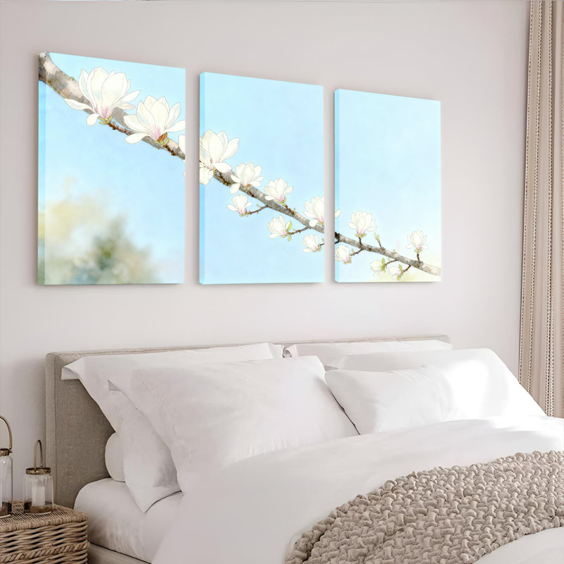 Ensemble de 3 tableaux sur toile tendue représentant une branche de magnolia blanche sur fond de ciel bleu, H 24 po x l 48 po