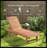 Outdoor Chaise Lounge Pool Chair With Built-In Side Table, Reclining Backrest For Sun Tanning & Sunbathing, Smooth Rolling Wheels, Red Wood Look Finish