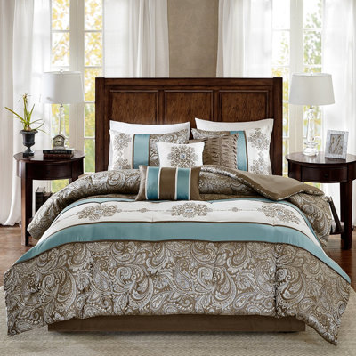Édredon 7 pièces en bleu pour très grand lit avec motif cachemire et bordure brune invitante