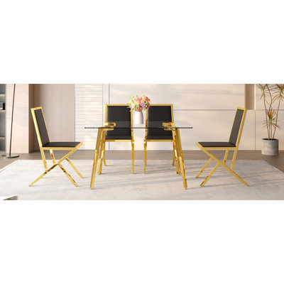 Ensemble de table et de chaises Table de salle à manger de 51 x 31,5 pouces en verre trempé, jumelée à un ensemble de 4 chaises de salle à manger en polyuréthane noir. Ensemble de table et de chaise de restaurant moderne et luxueux.