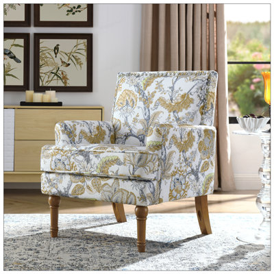 Chaise d'appoint chic à motif botanique avec garniture cloutée et pieds en bois massif, idéale pour les décors campagnards et transitionnels.