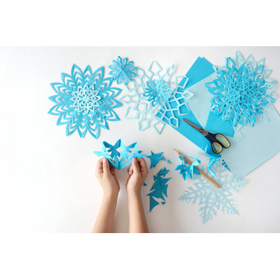 Child Making Snowflakes - Wrapped Canvas Print