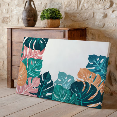 La toile crée un motif de feuilles tropicales vibrantes avec une variété d'art mural de grandes feuilles stylisées dans des tons de vert foncé sarcelle, art mural sur toile