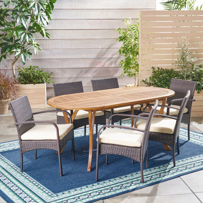Thomes 6 - Person Acacia Wicker Patio Dining Set with Oval Table , Cushions Included