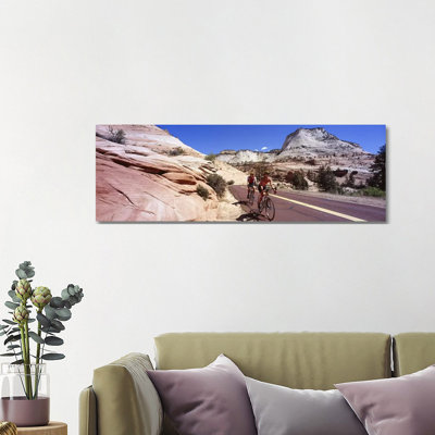 Two People Cycling On The Road, Zion National Park, Utah, USA by Panoramic Images - Wrapped Canvas Panoramic Print