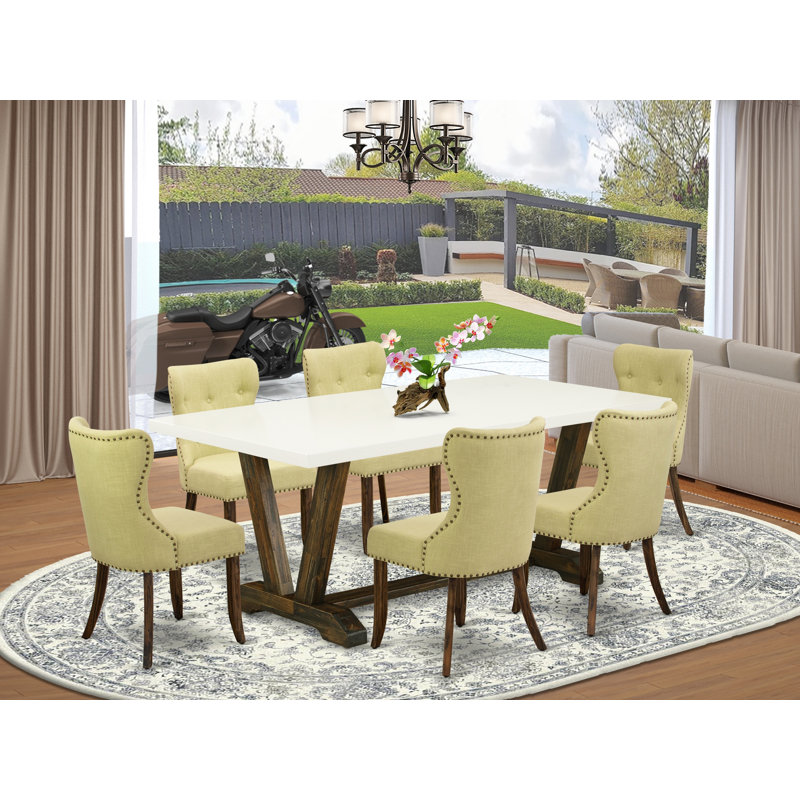L'ensemble de table de salle à manger 7 pièces se compose d'une table rectangulaire en lin blanc et de 6 chaises de cuisine Limelight en tissu de lin au fini jacobien vieilli
