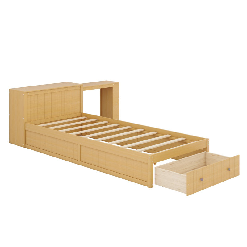 Lit plateforme avec bureau intégré et rangement, offrant une grande tablette en tête de lit et des tiroirs au pied du lit.