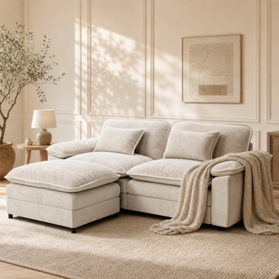 Canapé d'angle modulaire de 218 cm, canapé nuage en forme de L pour salon, beige, 3 places confortables, structure robuste, tissu chenille doux, avec 2 coussins décoratifs et un pouf amovible.