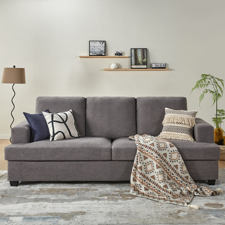 Modern style sofa with contrasting tufted back cushions