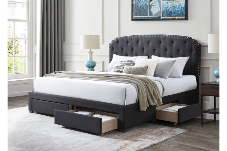 a queen size bed with two standard pillows and several decorative pillows