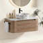 Meuble-lavabo élégant et incurvé avec rangement à fermeture en douceur et porte-serviettes intégré