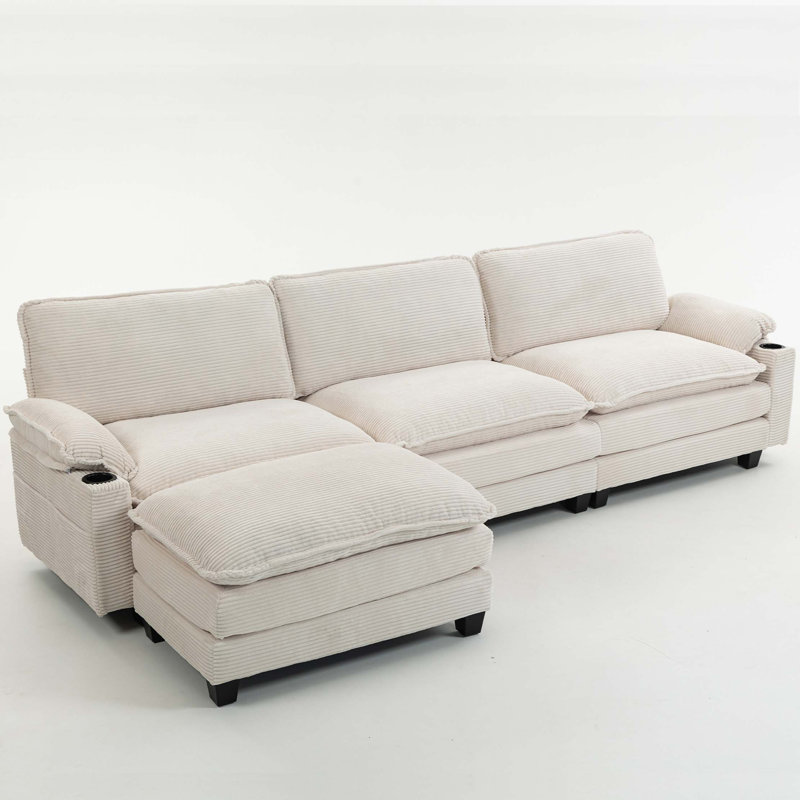 113" Modern 3+1 L-Shaped Corduroy Fabric Sofa,Modular Sectional Cloud Couch W/Ottoman,35D High-resilience Sponge&Double-layer Thick Cushion,Cup Holders,Storage Bags