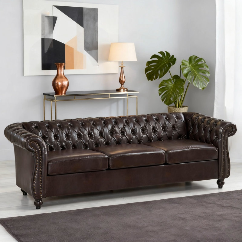 Classic Chesterfield 3-Seater Sofa with Button Tufting, Scrolled Arms, and Elegant Nailhead Trim for Timeless Living Room Style.