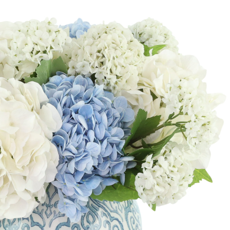 Arrangement d'hortensias et de viornes dans un vase décoratif