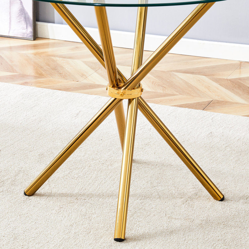 Table de salle à manger ronde en verre transparent avec pieds en métal pour les espaces modernes