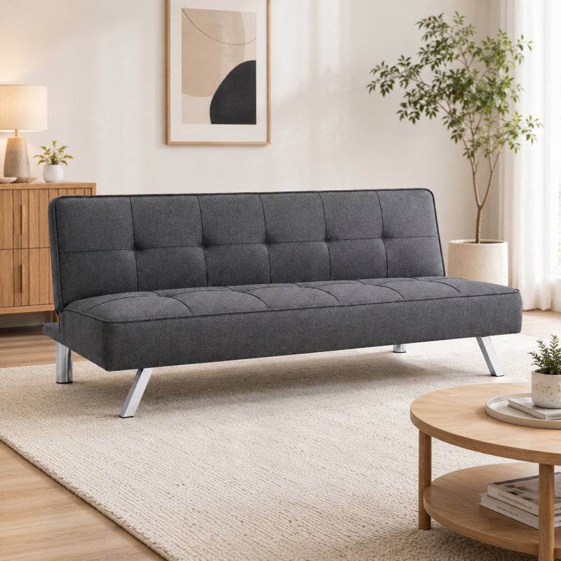 Mobilier gris pliant en tissu à double usage, placé dans le salon, en un clic entre le canapé et le lit