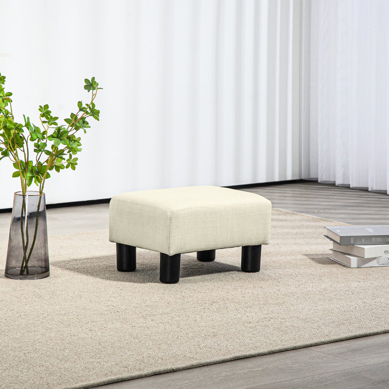 Repose-pieds cubique beige avec housse en lin, petit espace de repos, pièce