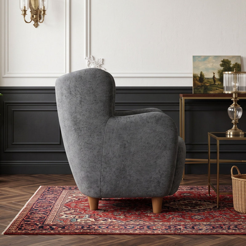 Fauteuil à oreilles en velours avec coussin à ressorts ensachés et pieds en bois massif
