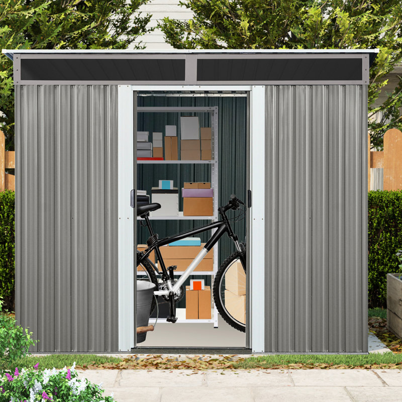 Abri de jardin en métal de 2,4 m x 1,8 m avec structure à ossature apparente - Structure stable et résistante, de couleur grise, reposant sur des fondations solides.